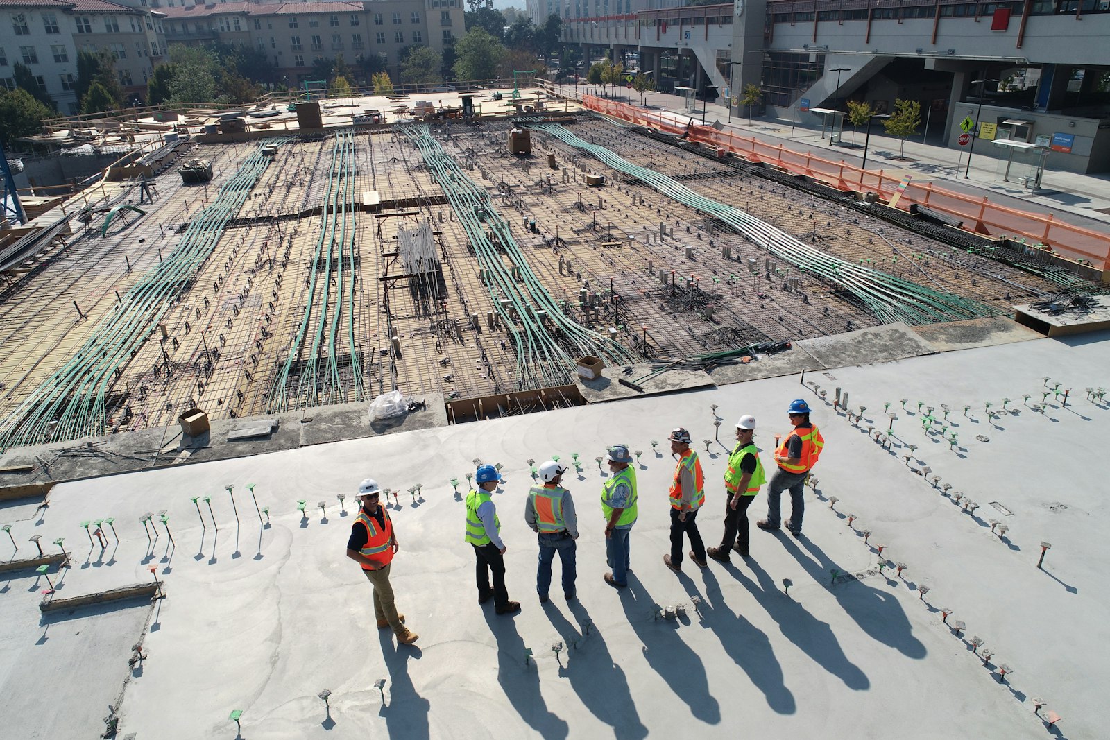 Engineers reviewing a concrete deck pour on a commercial job site
